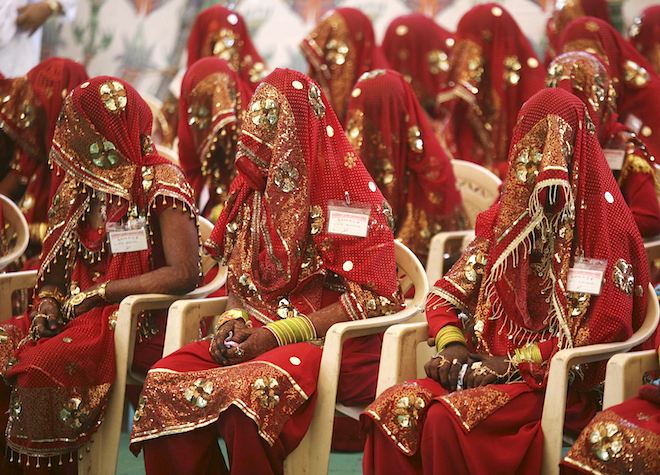 Brides wait for the start of their marriage ceremony